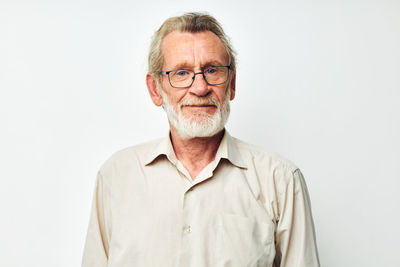 Portrait of man standing against white background