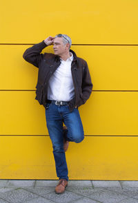 Portrait of man on yellow wall