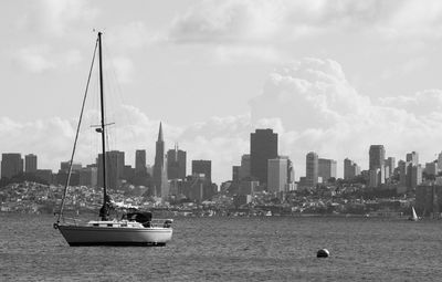 Sailboat sailing on san francisco bay against cityscape