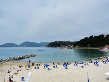 Group of people on beach against sky