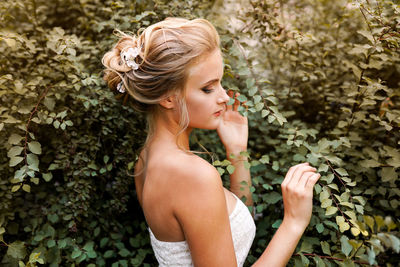 Portrait of a beautiful young woman with red eyes closed