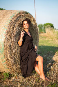 Portrait of a smiling young woman on field