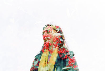 Double exposure of cherries and woman against white background