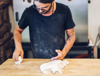 Midsection of man working on table