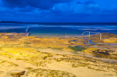 Ocean rock pool and beach at night nature background. long exposure