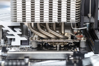 Macro shot of a modern desktop motherboard with a heatsink mounted on the cpu on the socket lga.