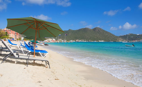 Scenic view of beach against blue sky