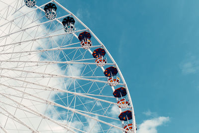 Low angle view of ferris wheel against sky