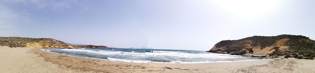 Panoramic view of beach against clear sky