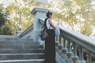 Woman standing by railing