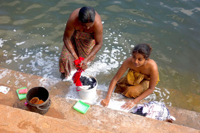 Young couple sitting in water