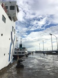 Boats moored on sea against sky