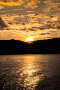 Scenic view of sea against romantic sky at sunset