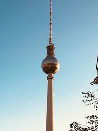 Low angle view of communications tower against sky