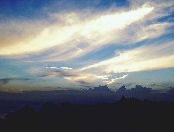 Scenic view of mountains against cloudy sky