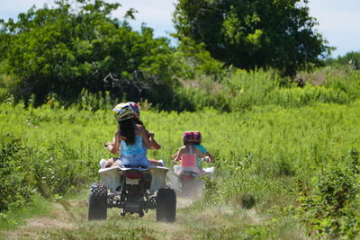 People riding motorcycle on field
