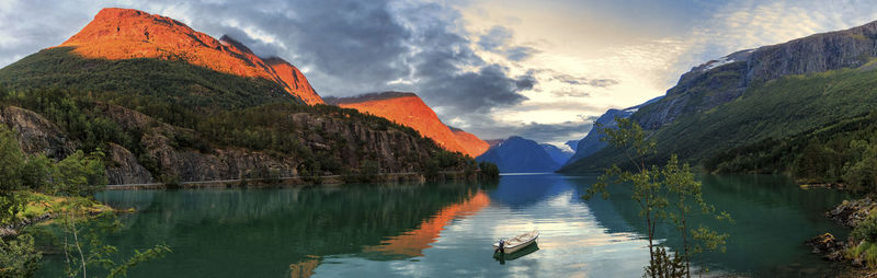 Scenic view of lake and mountains against sky