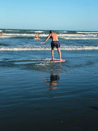 Full length of boy standing on beach