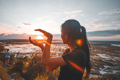 Side view of woman on beach during sunset