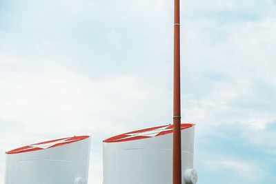 Low angle view of pole against cloudy sky