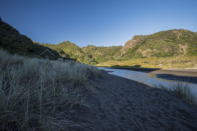 Scenic view of beach against clear blue sky