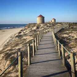 Pier over sea against clear sky