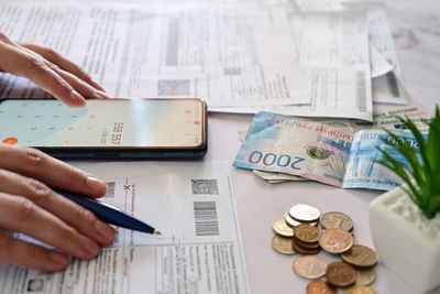 Cropped hands of businessman working on table