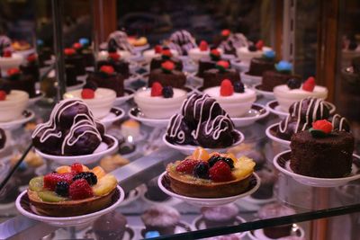 Close-up of sweets served on glass display