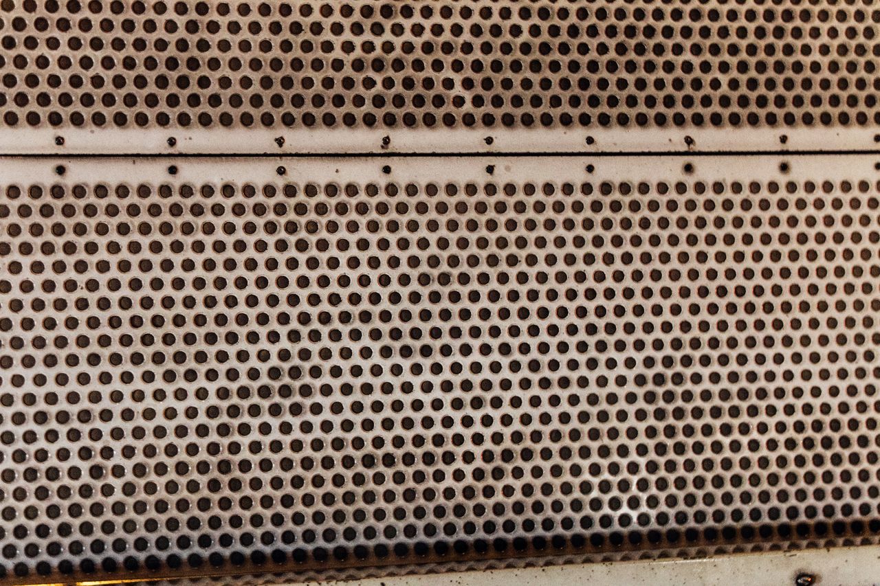 CLOSE-UP OF PATTERNED OF METAL