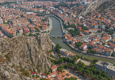 High angle view of townscape by river in city