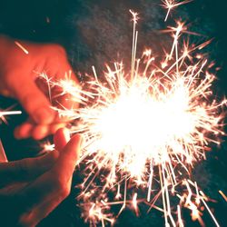 Low angle view of firework display at night