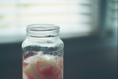 Close-up of water in glass jar on table