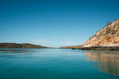 Scenic view of sea against clear blue sky