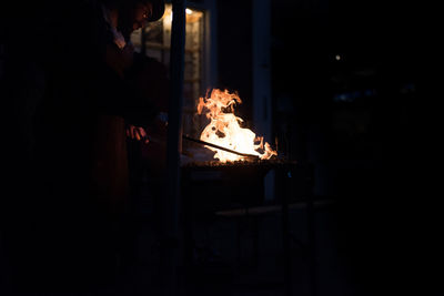 Close-up of man burning at night