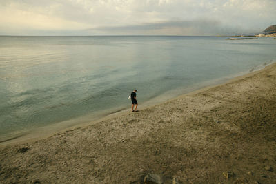 Man on beach against sky