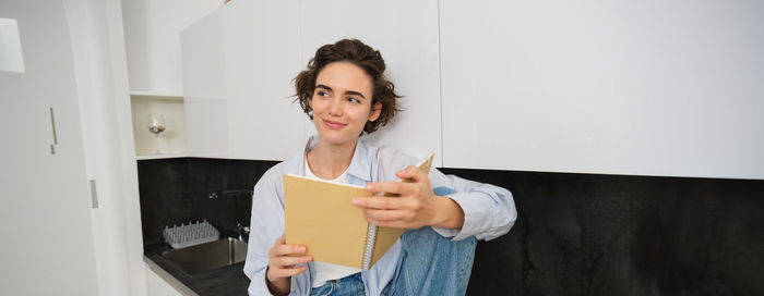 Portrait of young woman using mobile phone