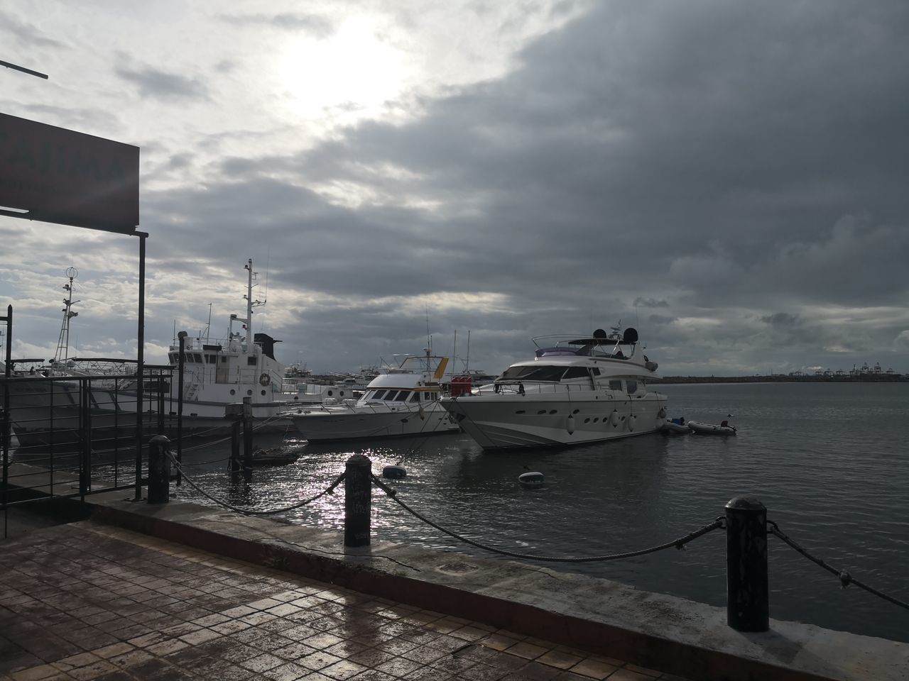 SCENIC VIEW OF HARBOR AGAINST SKY