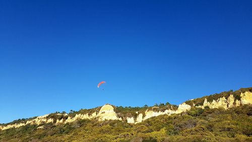 Low angle view of mountain against blue sky