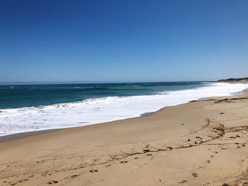 Scenic view of beach against clear sky