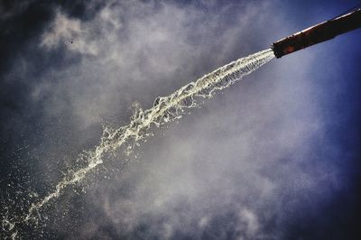 Low angle view of water flowing from hose