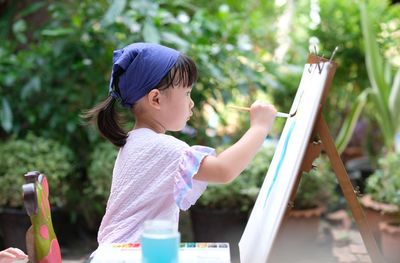 Side view of girl holding ice cream