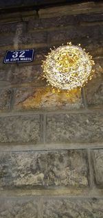 Low angle view of illuminated text on wall