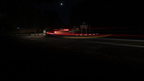 Red light trails on road in city at night