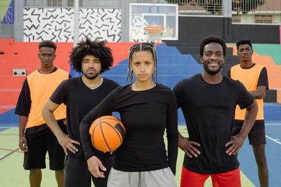 Portrait of young man playing basketball