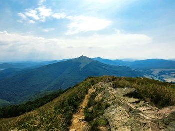 Scenic view of mountains against cloudy sky