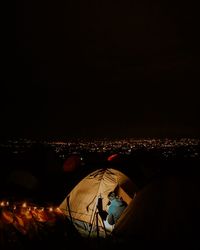 High angle view of illuminated cityscape against sky at night