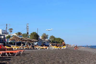 Scenic view of beach against clear blue sky