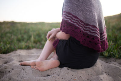 Low section of woman on sand
