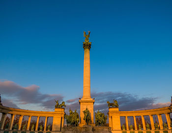 Low angle view of statue against blue sky