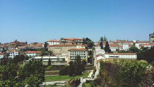 Buildings in city against blue sky